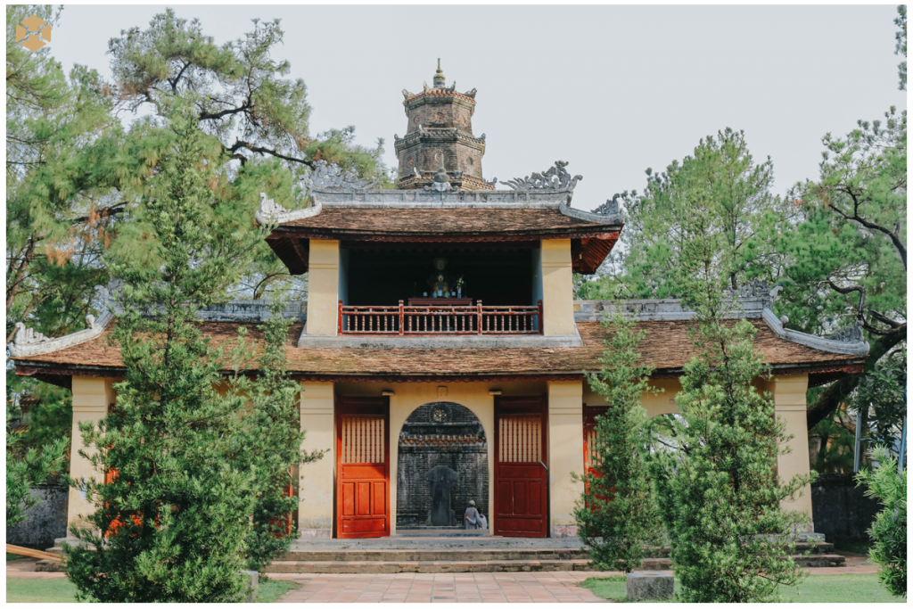 The entrance to Thien Mu Pagoda is marked by a grand gate decorated with vibrant colors and intricate patterns.